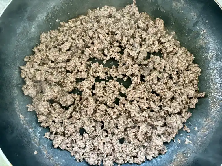 Cooked ground beef in a wok.