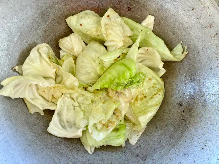 Fried cabbage in a wok.