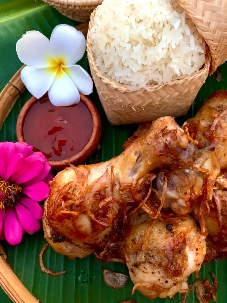 Hat yai fried chicken served with sweet chili sauce and Thai sticky rice.