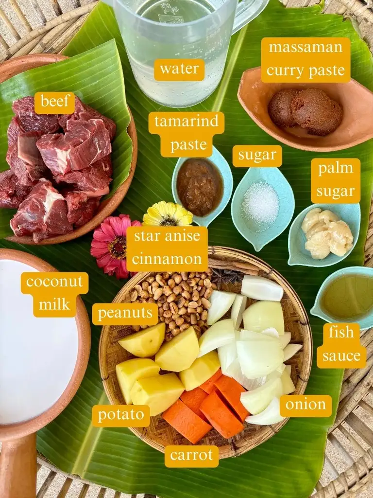 Ingredients for gaeng massaman neua labeled: beef, water, massaman curry paste, tamarind paste, salt, palm sugar, star anise, cinnamon, fish sauce, peanuts, coconut milk, onion, carrot, and potato.