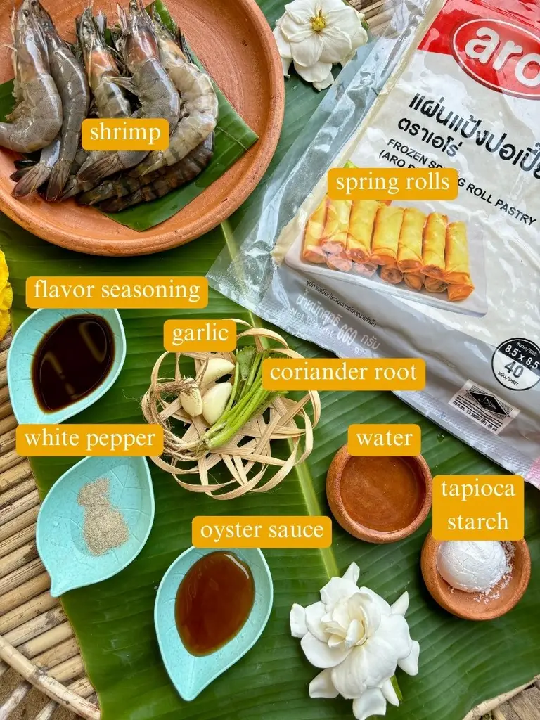 Top-view of ingredients for shrimp in a blanket: shrimp, spring rolls, flavor seasoning, garlic, coriander root, white pepper, water, tapioca starch, water, and oyster sauce.