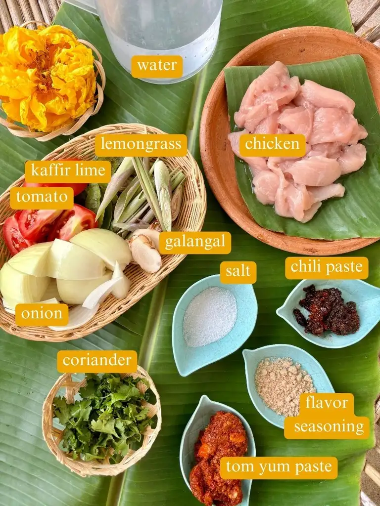 Ingredients for Thai lemongrass soup labeled: water, chicken, lemongrass, kaffir lime, tomato, galangal, salt, chili paste, coriander, flavor seasoning, tom yum paste.