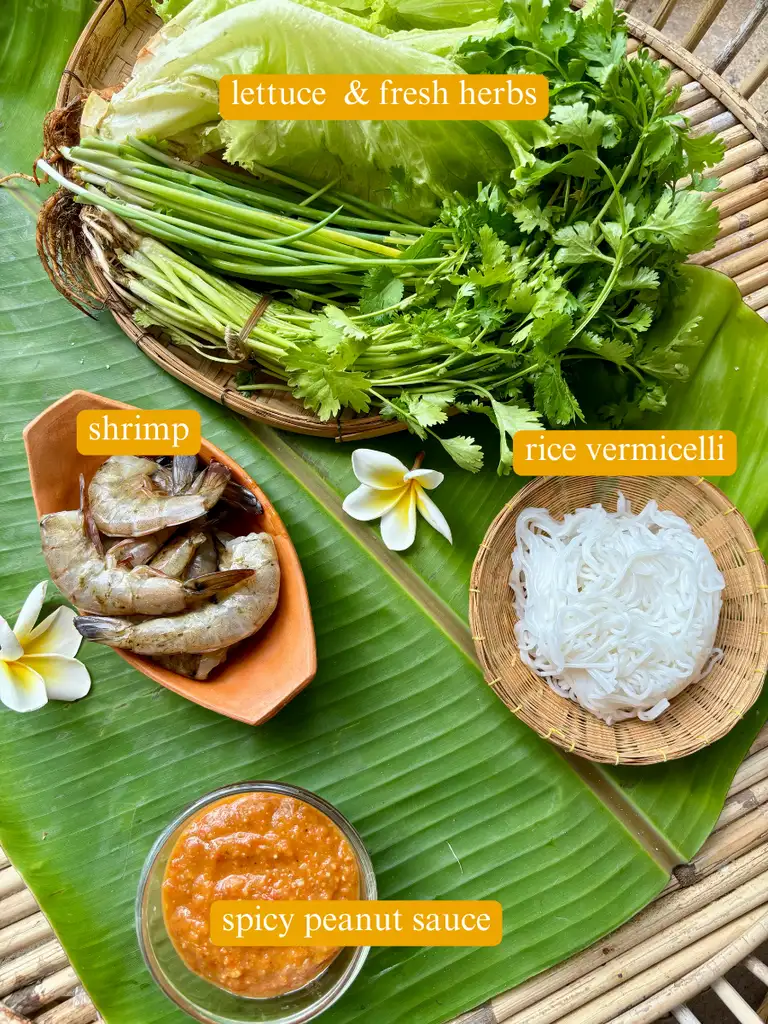 Ingredients for Thai shrimp lettuce wraps: lettuce & fresh herbs, rice vermicelli, shrimp, and spicy peanut sauce.