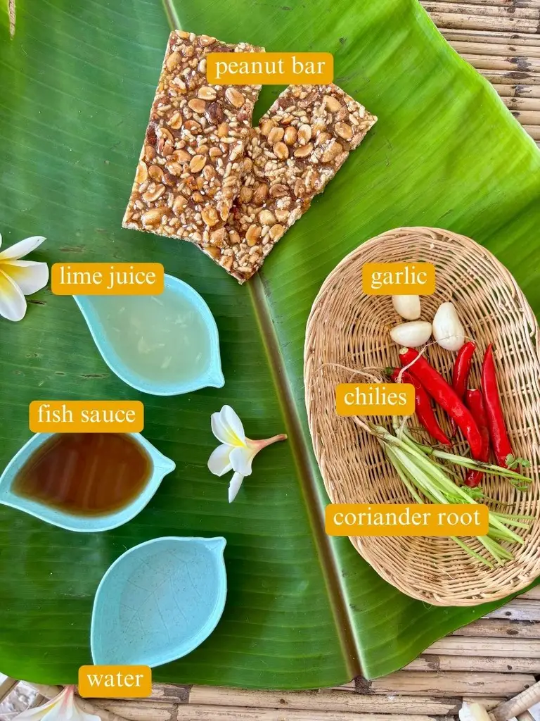 Ingredients for Thai spicy peanut sauce: coriander root, chilies, garlic, water, fish suace, lime juice, and peanut bars.