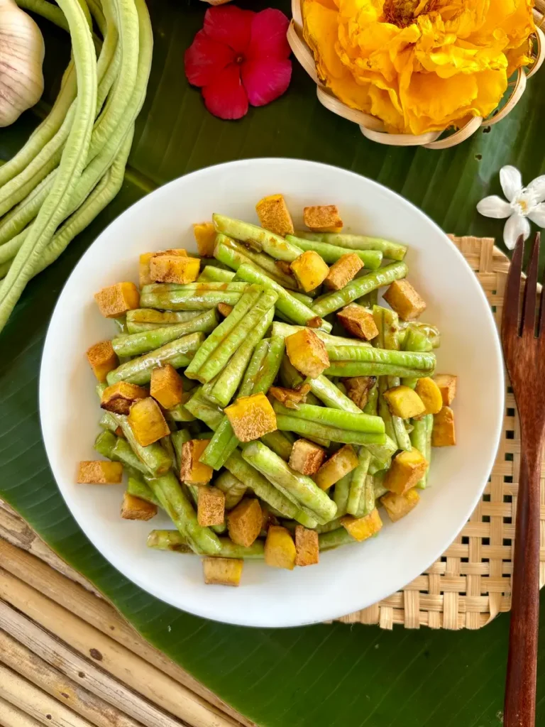 Long beans stir-fry with tofu, served in a white dish.