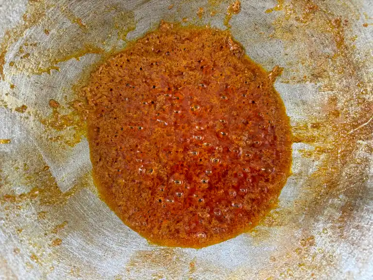 Simmering massaman curry paste in a wok.