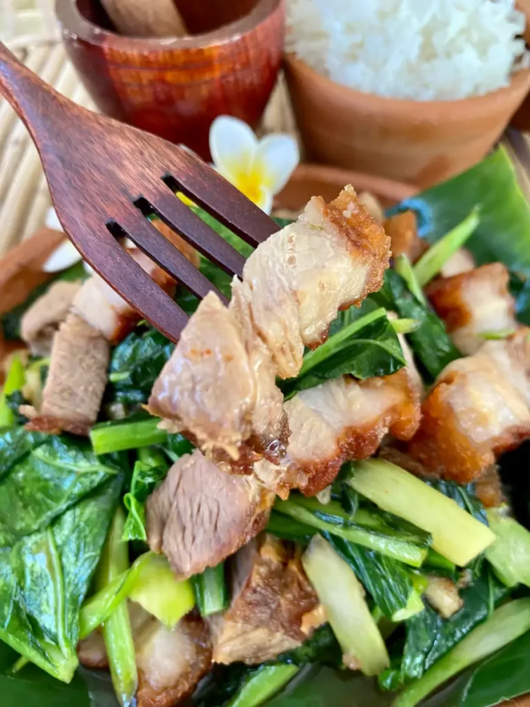 Close-up of pad kana moo grob, Thai crispy pork with Chinese broccoli.