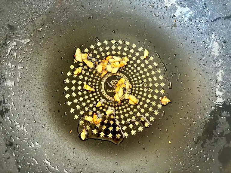 Sautéed minced garlic in a wok.