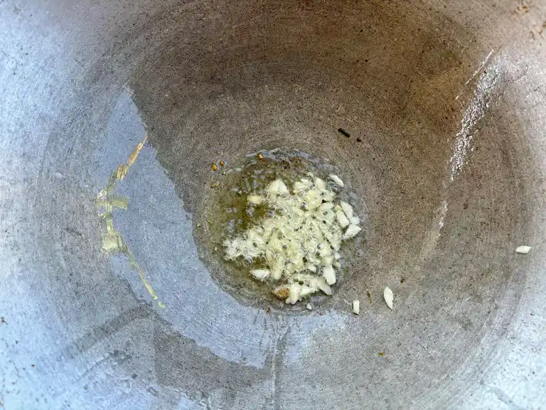 Garlic sizzling in a wok.