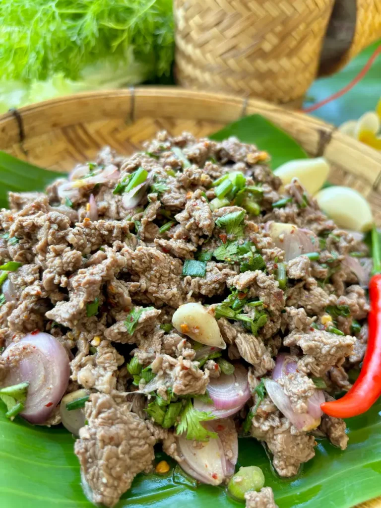 Close-up of Thai beef larb highlighting the tender ground beef mixed with sliced shallots, fresh herbs, and a hint of chili.