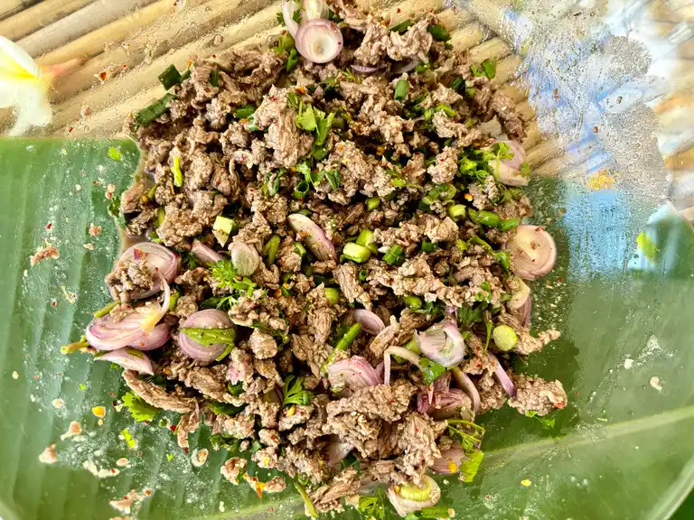 Thai ground beef larb prepared in a clear bowl.