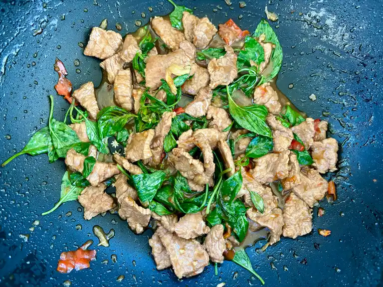 Stir-fried pad horapa with wilted basil and beef.