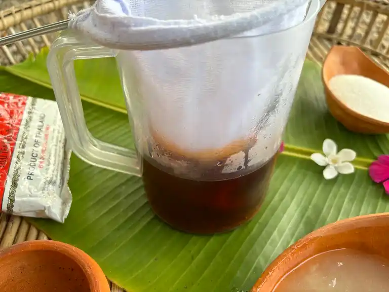 Dark Thai tea steeping in a pitcher.