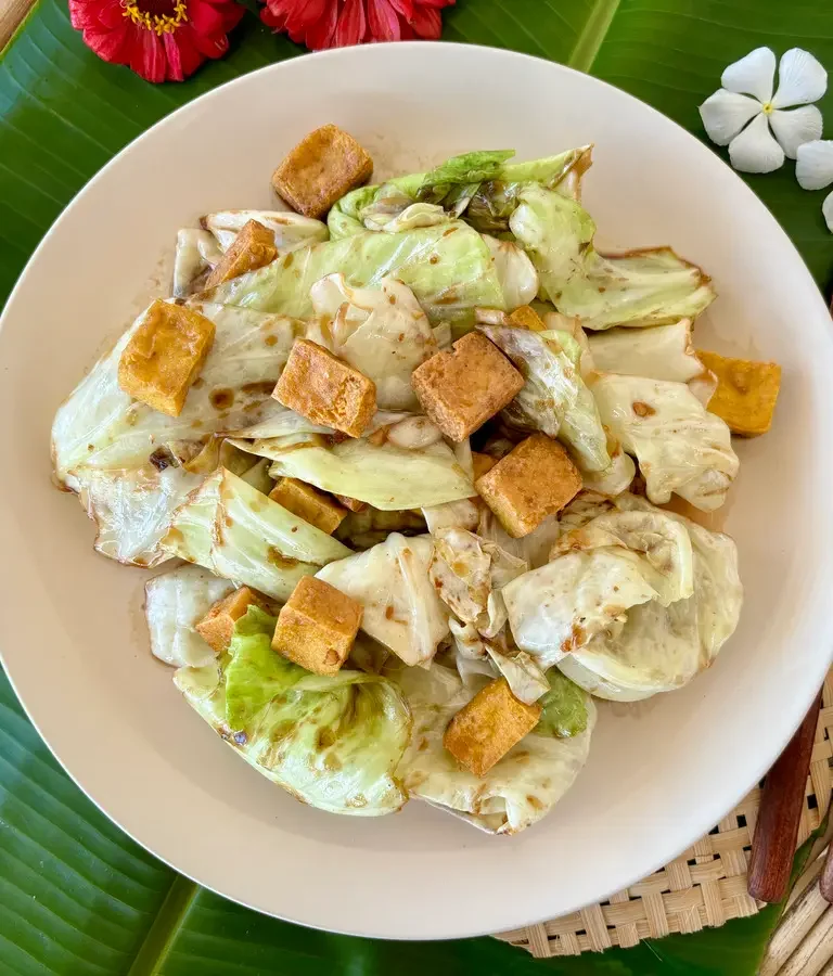 Vegetarian fried cabbage tofu served in a white dish.