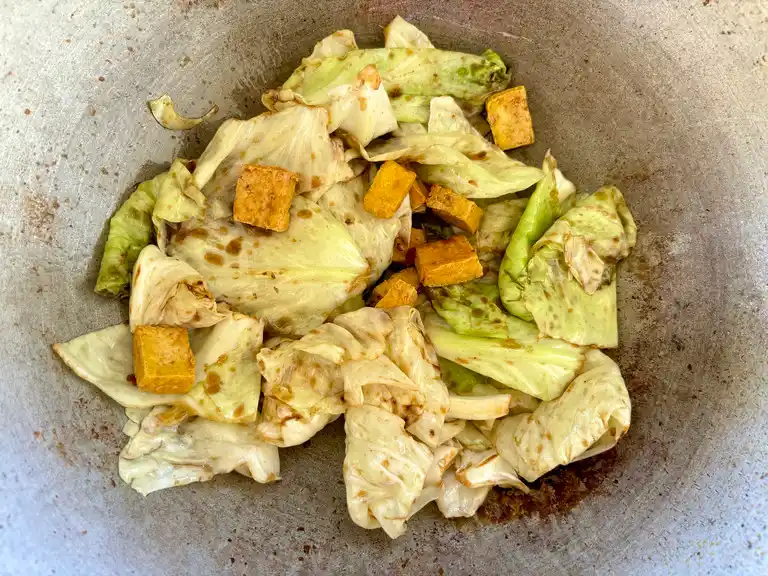 Vegetarian fried cabbage with tofu ready in wok.