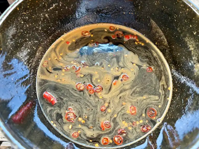 Dipping sauce preparation in wok.