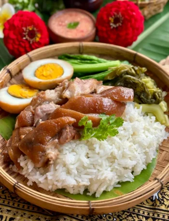Khao kha moo, Thai braised pork leg, with hard-boiled eggs, jasmine rice, and pickled mustard greens.