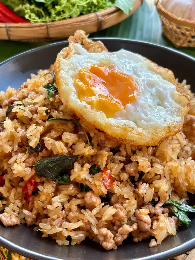 Close-up of khao pad krapow with minced pork and a fried egg.