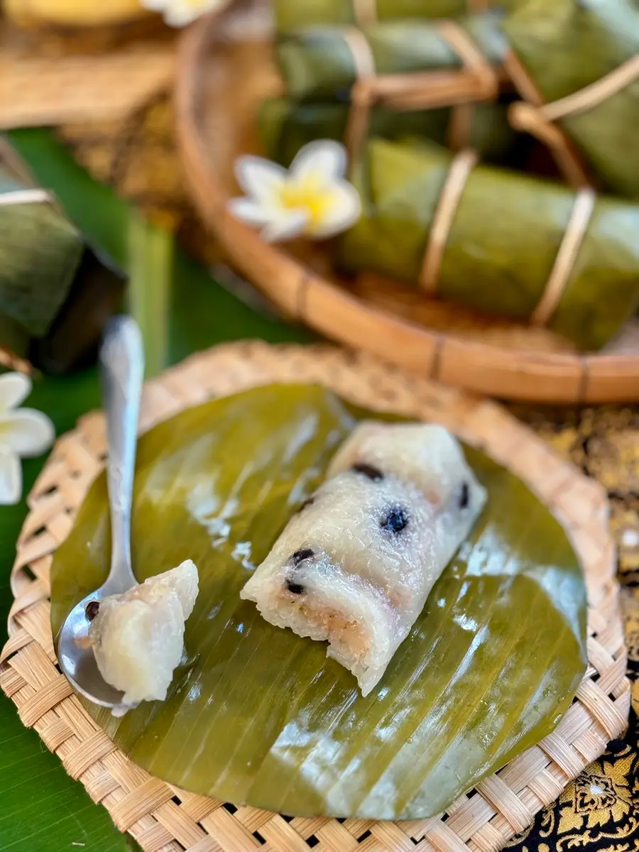 Unwrapped khao tom mud revealing the tender, sticky rice with black beans, ready to enjoy.