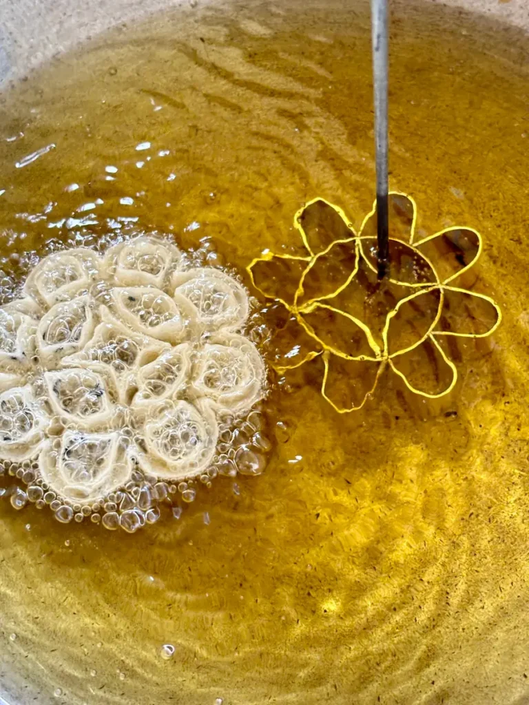 A lotus flower mold with Thai cookie in oil.