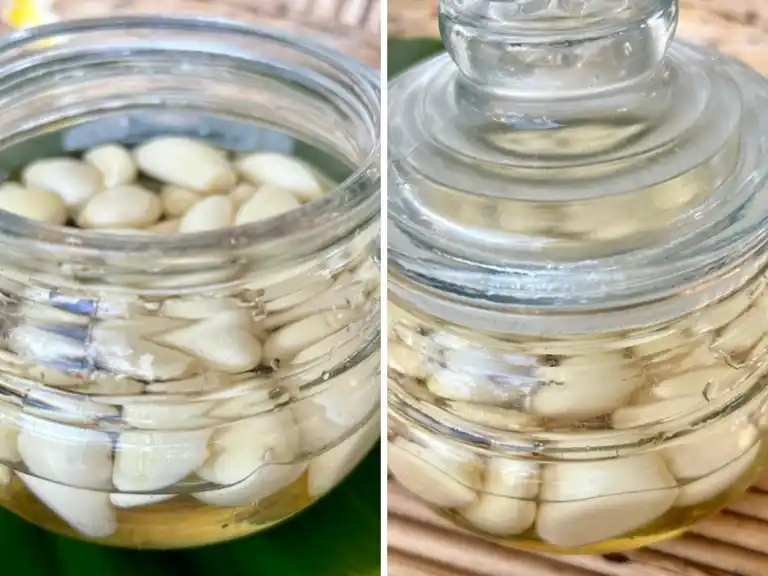Two angles of a jar filled with Thai pickled garlic cloves in brine.