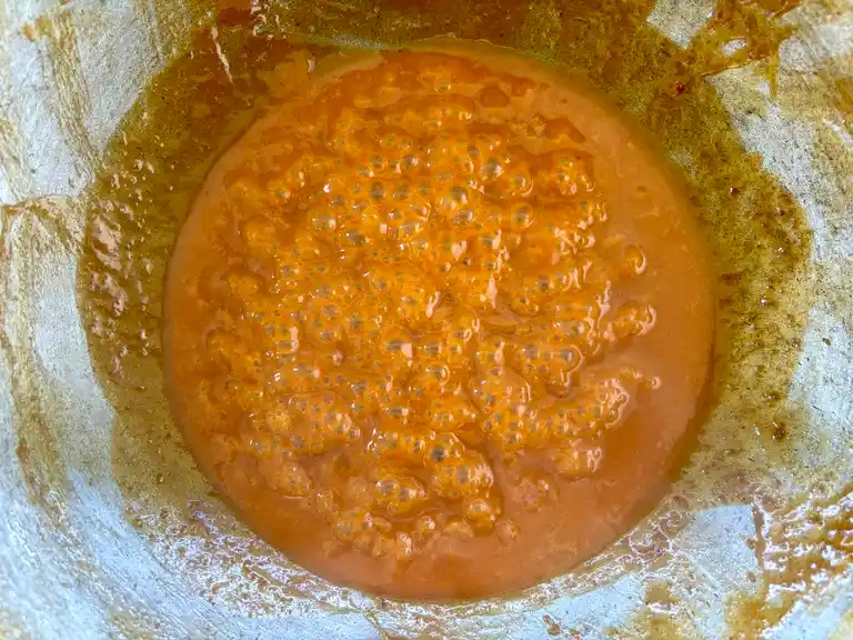 Peanut sauce cooking in a wok.
