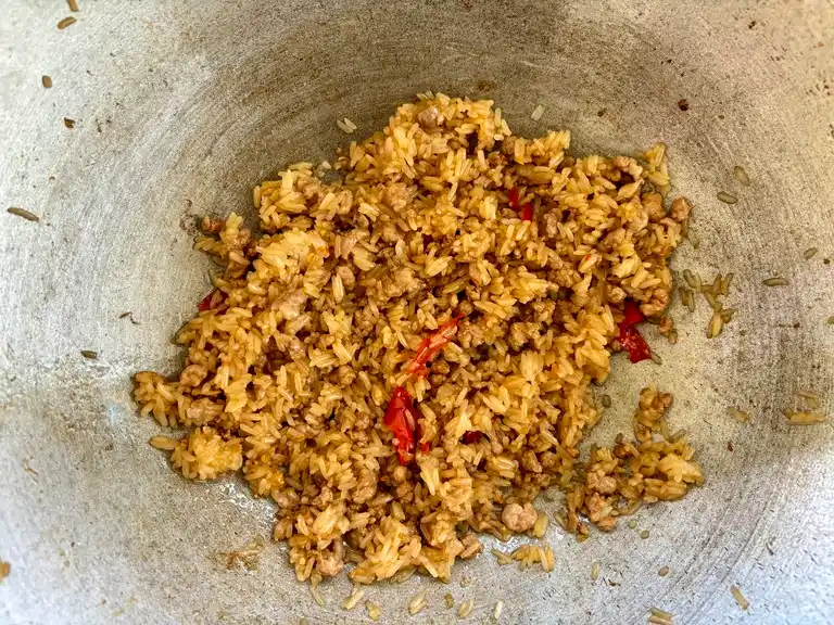 Fried rice ground pork mixture cooking in a wok.