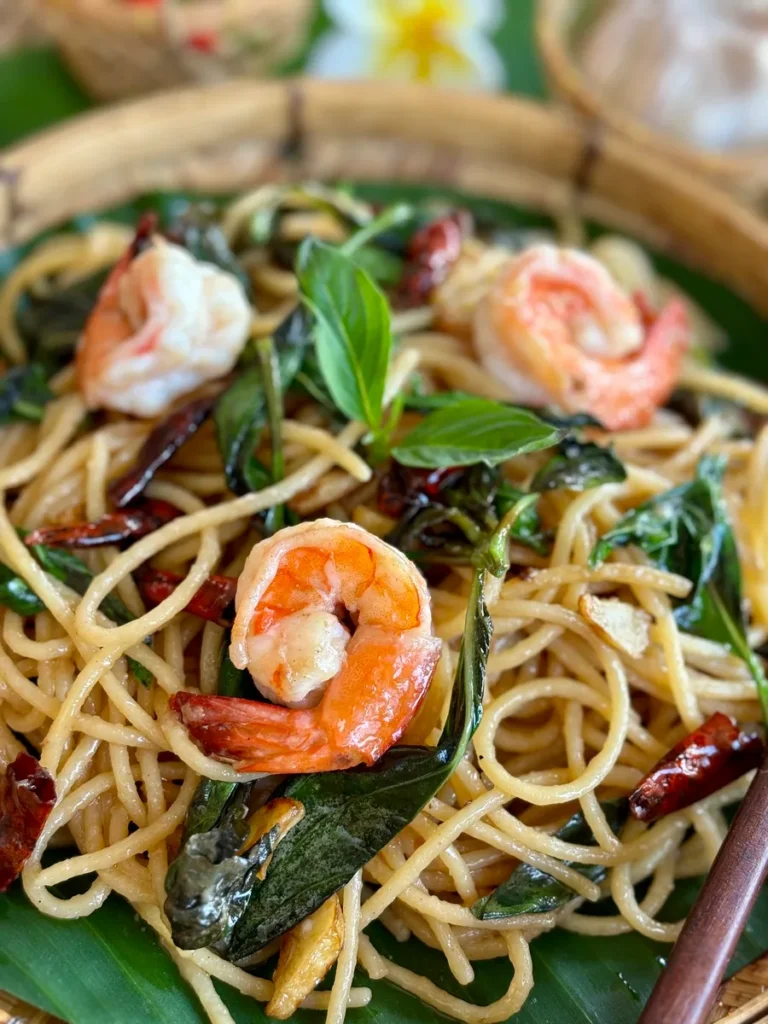 Close-up of Thai basil pasta with shrimp and spaghetti noodles.