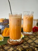 Thai tea, cha yen, in a tall glass with ice.