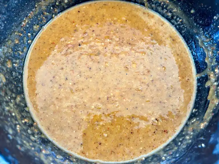 Thai peanut sauce prepared in a wok.