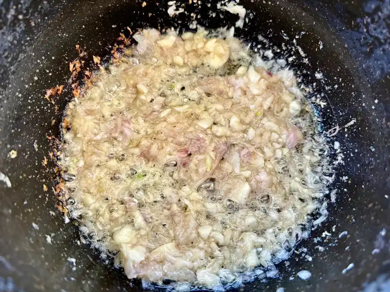 Shallots frying in a pan.
