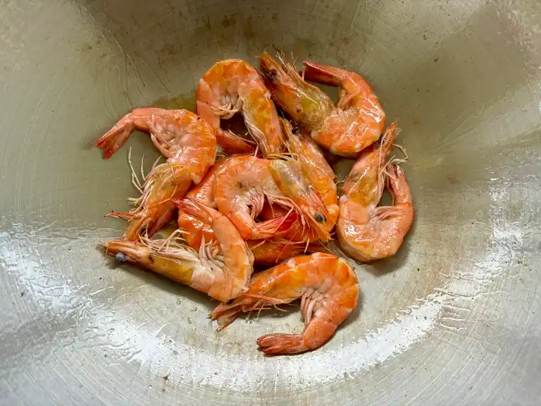 Cooked shrimp in a wok.