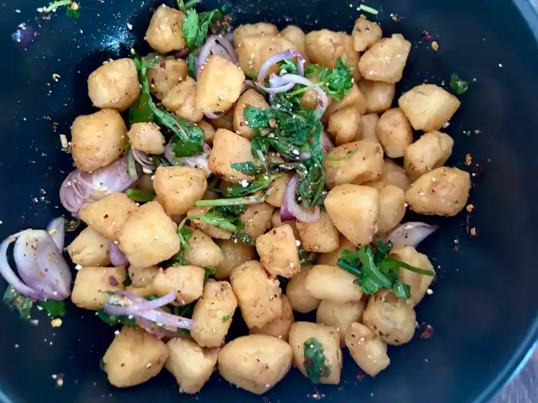 Ready-made Thai egg tofu salad in a black salad bowl.