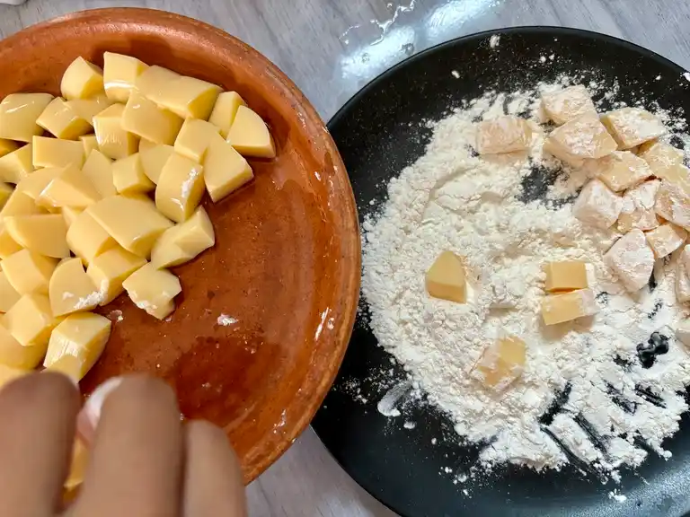 Egg tofu coated in tempura flour for frying.