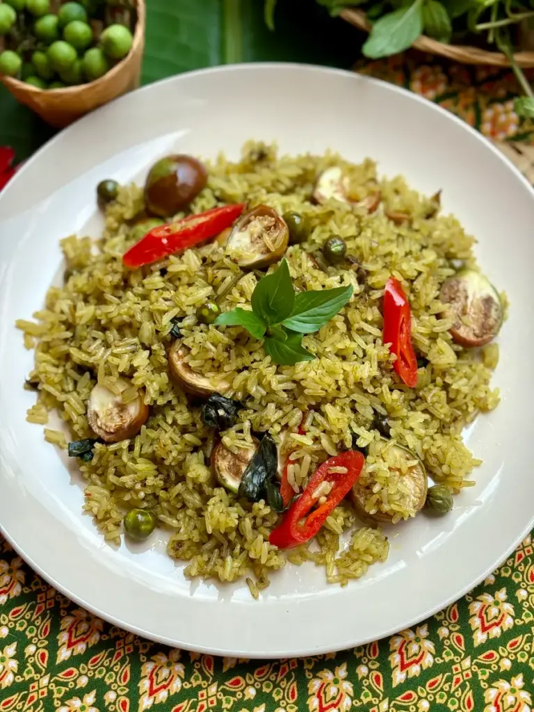 Thai green curry fried rice, or gaeng keow wan, served in a white dish.