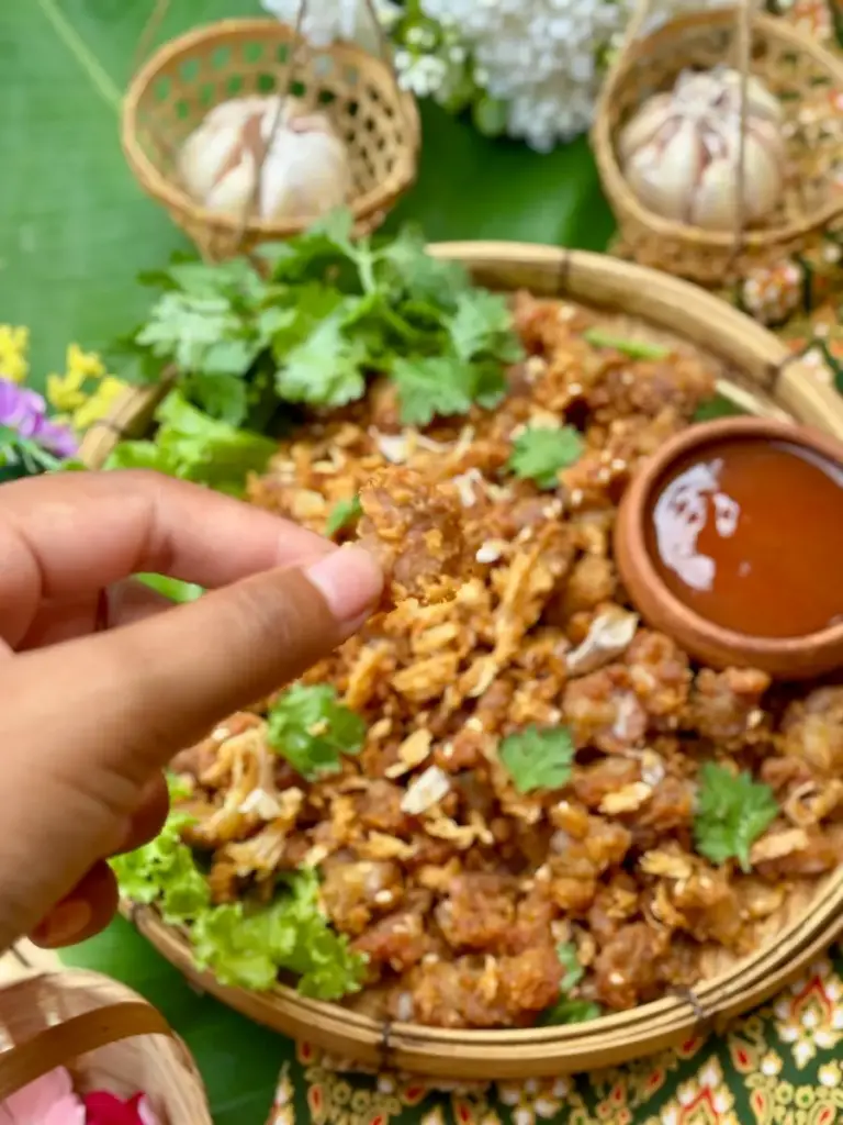 Thai fried chicken knuckles served with dipping sauce.