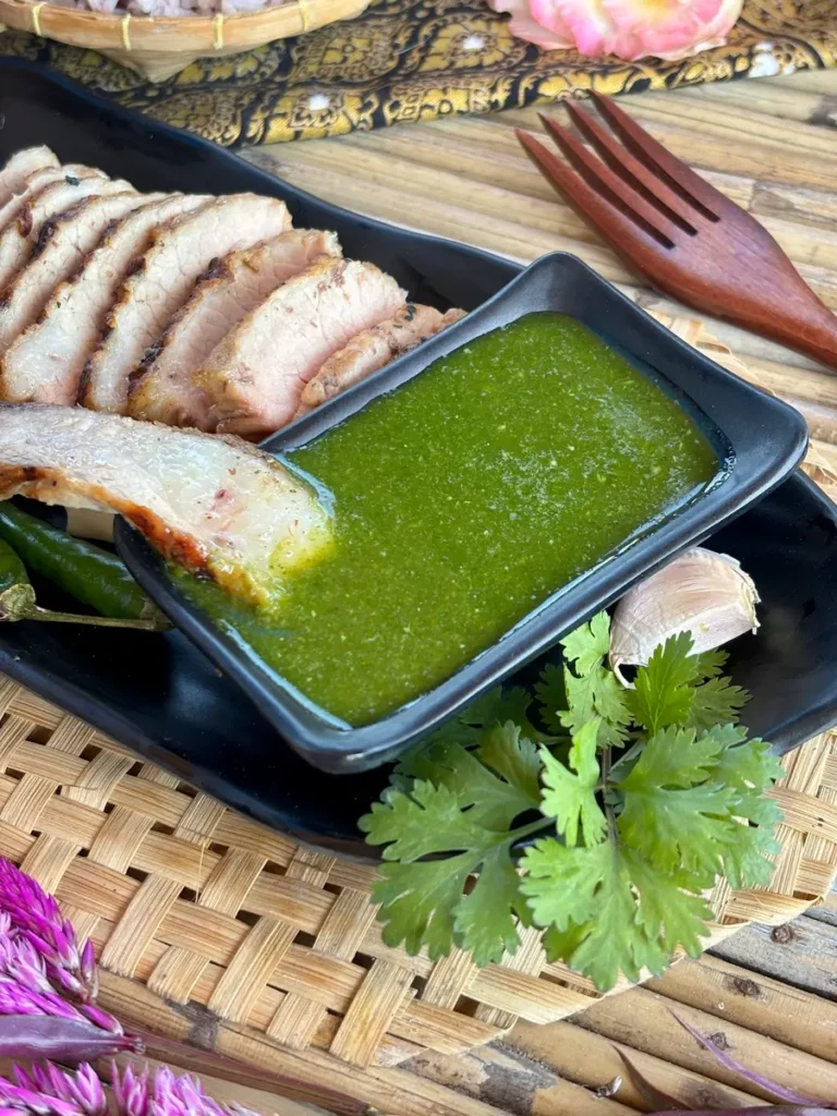 Closeup of Thai coriander sauce in a black bowl.