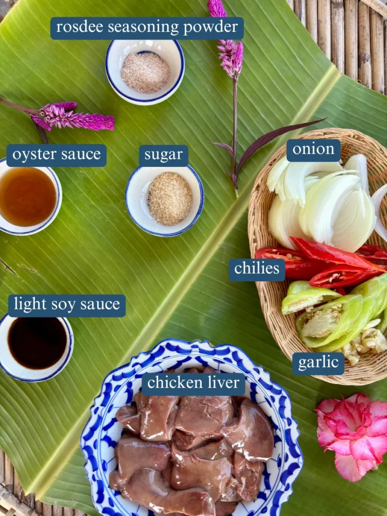 Ingredients for frying chicken livers, including raw chicken liver, chili peppers, onion, garlic, and seasonings such as soy sauce and oyster sauce.