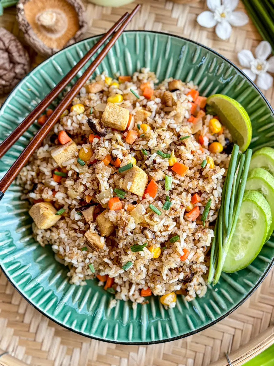 Top-view of Thai vegetarian fried rice featuring golden-browned tofu, fresh vegetables, and aromatic jasmine rice.