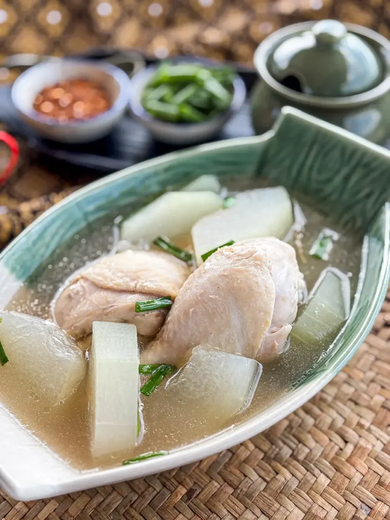 I snap in the head of the Thai winter melon soup with chicken chopsticks, light broth and green onion contour.