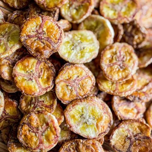 Crispy air fryer banana chips served on a bamboo tray.