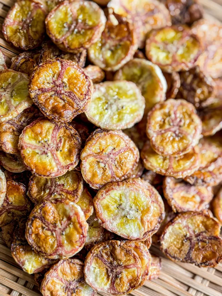 Crispy air fryer banana chips served on a bamboo tray.