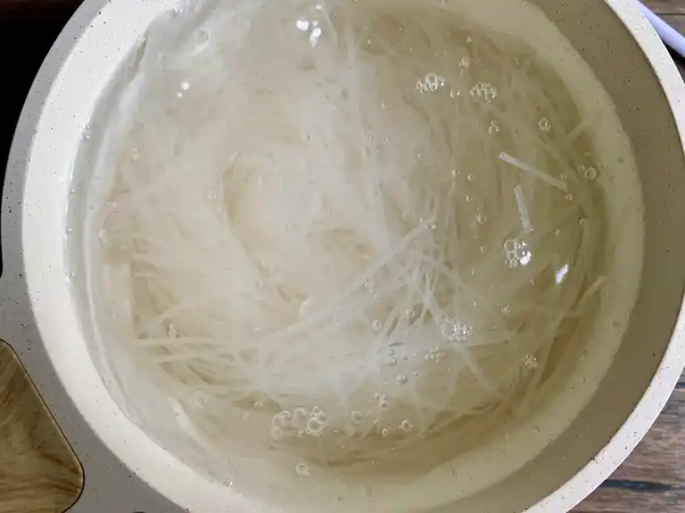 Rice noodles soaking in water.