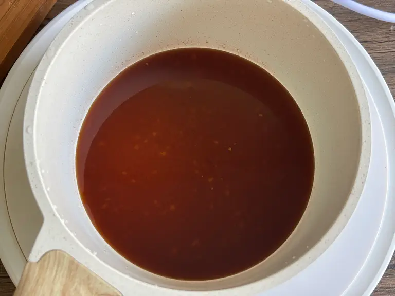 Sweet and sour stir-fry sauce in a saucepan.