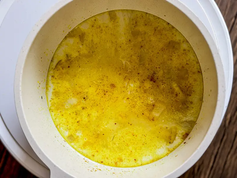 Water or broth added to yellow curry base, creating a golden curry soup.