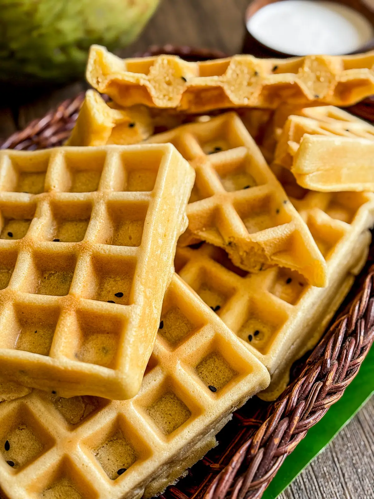 Coconut milk waffles stacked in a basket.