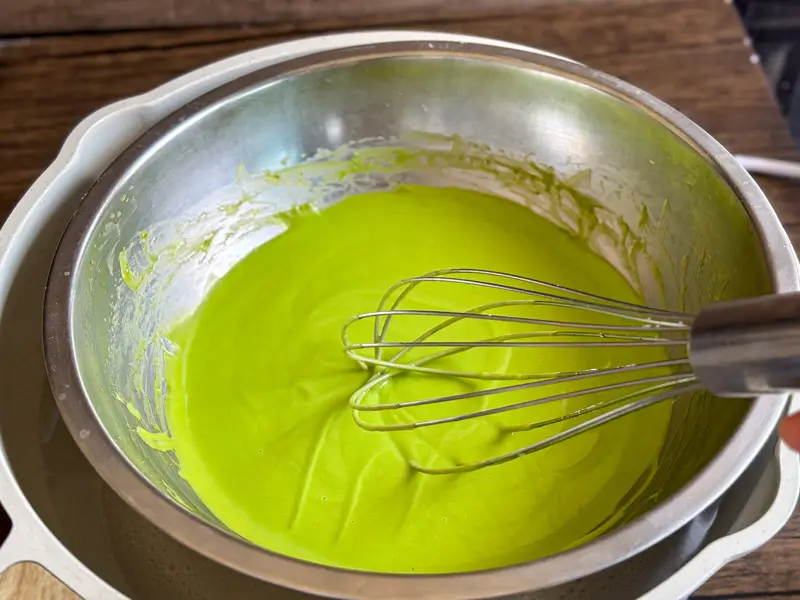 Pandan custard gently cooked over a double boiler while whisking until thick, glossy, and silky smooth.