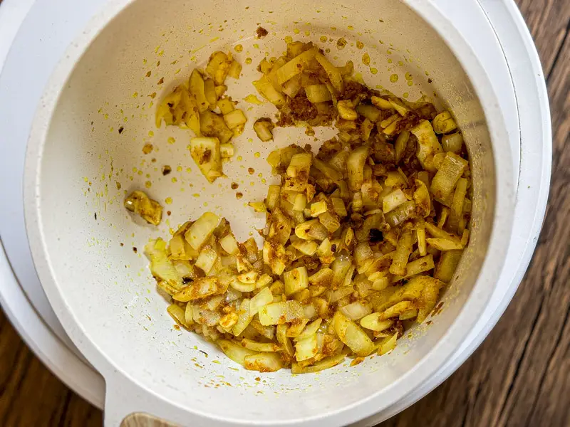 Chopped onion sautéed with yellow curry paste.