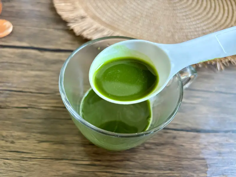 Dissolving Thai green tea powder in warm water.