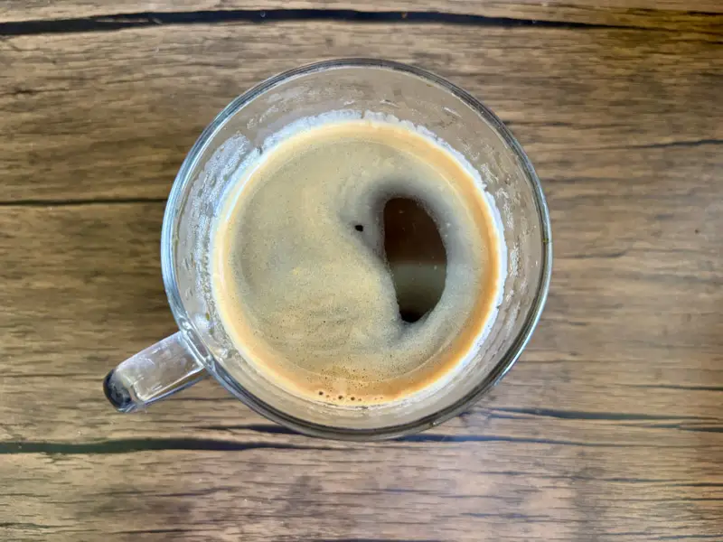 Freshly brewed coffee in a glass cup.